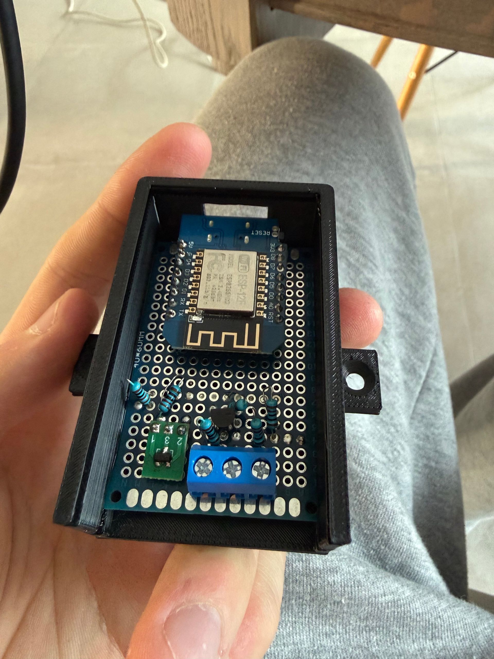 A custom-built board with a Wi-Fi chip in a black, 3D-printed case.
